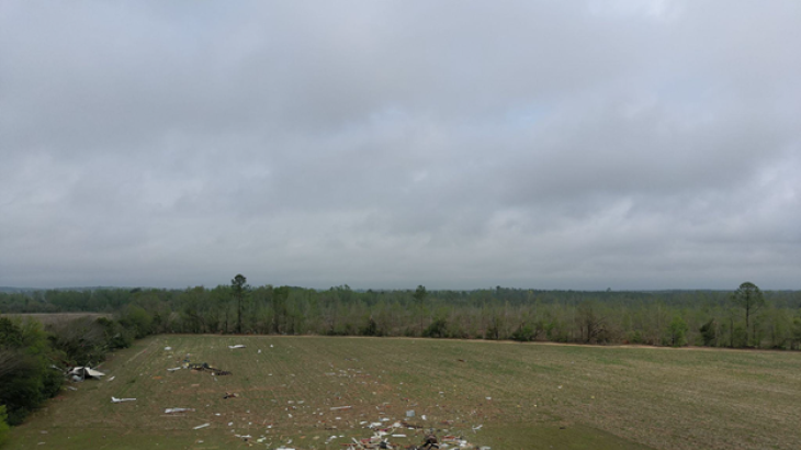 A birds eye view of damage following a tornado. The structure was completely destroyed with debris blown downstream.
