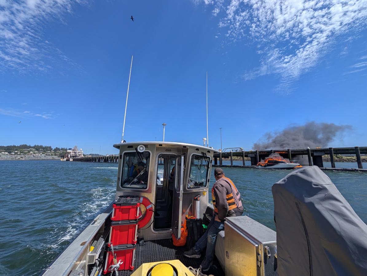 View from NOAA vessel of a boat on fire. Credit CDR Charles Wisotzkey