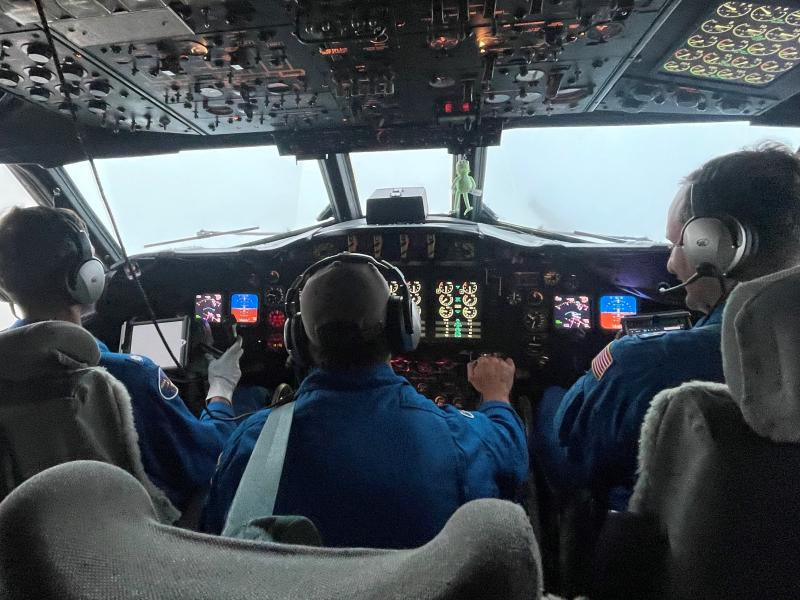 Pilots and flight engineer at the controls of NOAA WP-3D Orion N42RF during flight into Hurricane Ian