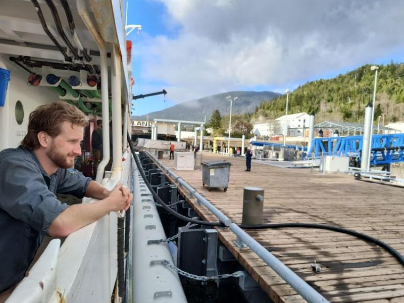 Sean Battles looks out from NOAA Ship Fairweather watching dockside activities.