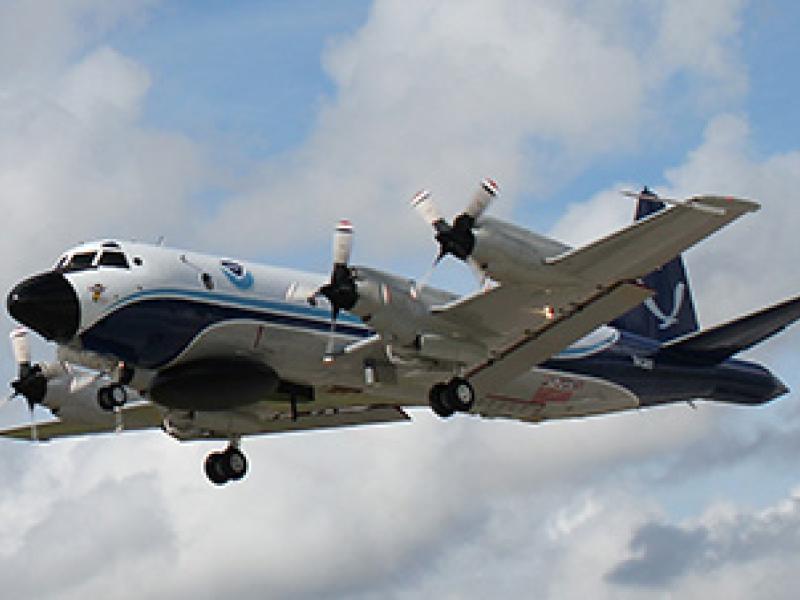 Four-engine propeller plane in the air