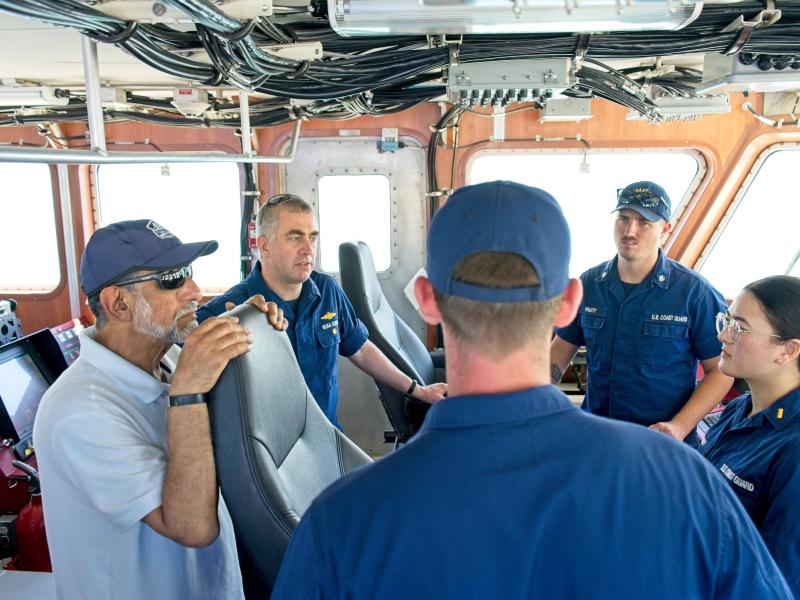 RDML Evans (second from left) talks with navigation partners. 