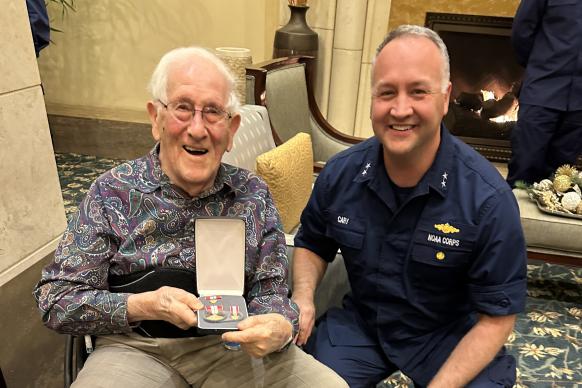 CAPT (ret.) Sam Baker with his award from RADM Chad Cary