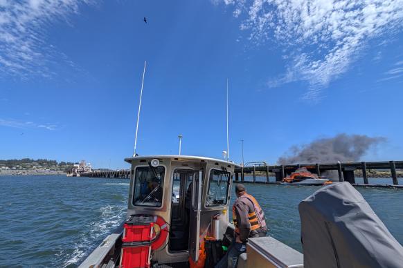 View from NOAA vessel of a boat on fire. Credit CDR Charles Wisotzkey