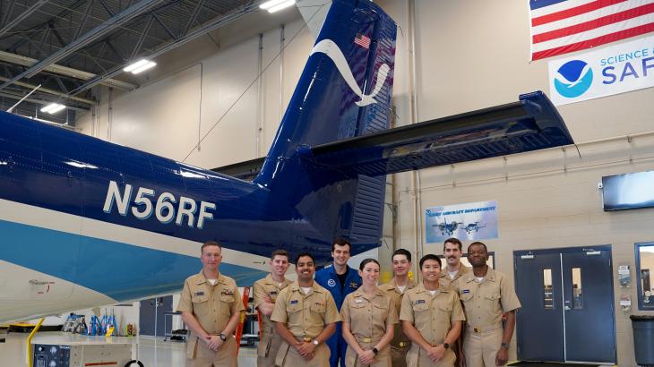 Newly commissioned NOAA Corps pilots stand in front of NOAA Twin Otter NOAA56 with Ensign Davis Benningfield and Lt. Eric Fritzsche during their tour of the NOAA Aircraft Operations Center in Lakeland, FL.(From L to R): ENS Dylan Legus-Sleigh, ENS Christian Eden, ENS Brian D'Souza, ENS Davis Benningfield, ENS Sara Towers, ENS James Seibert, ENS Wally Wibowo, Lt. Eric Fritzsche, ENS Ghislain Martial Ngangnang Ngangte