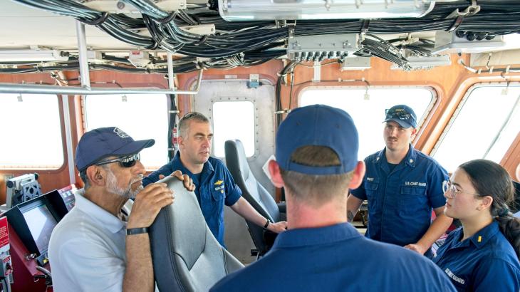 RDML Evans (second from left) talks with navigation partners. 