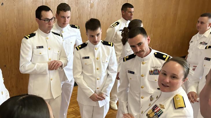 RDML Amanda Goeller (front right) talks to newly commissioned NOAA Corps officers. 