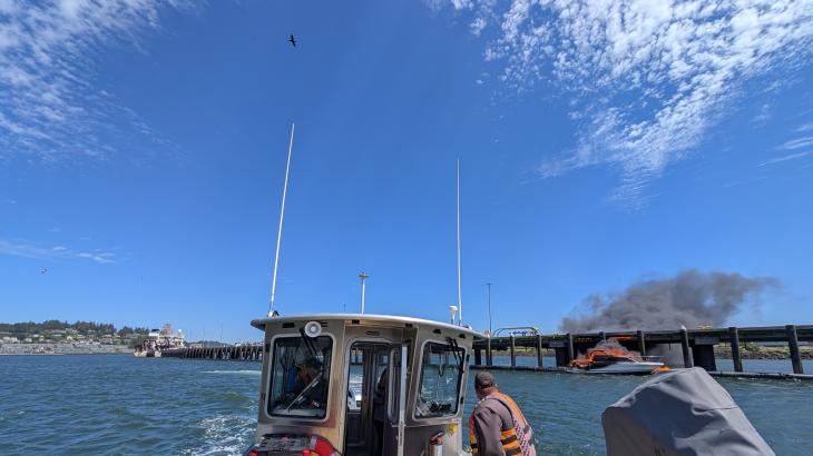 View from NOAA vessel of a boat on fire. Credit CDR Charles Wisotzkey
