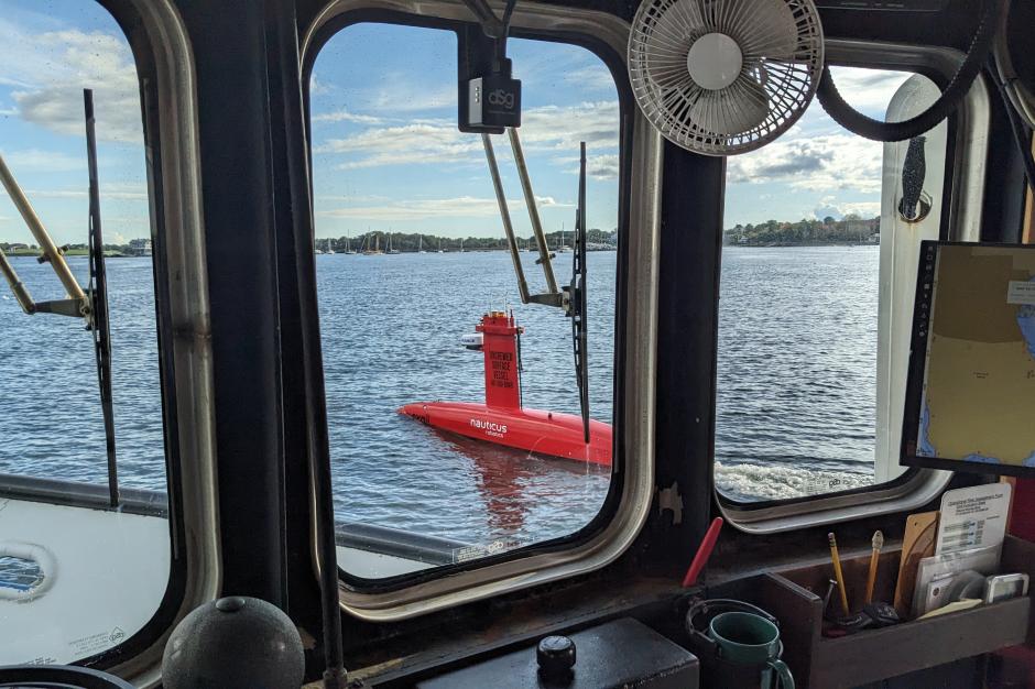 DriX uncrewed surface vehicle seen through a vessel window