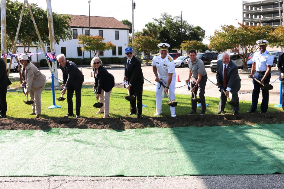 A group of people with shovels break ground on a new pier facility in Charleston, South Carolina