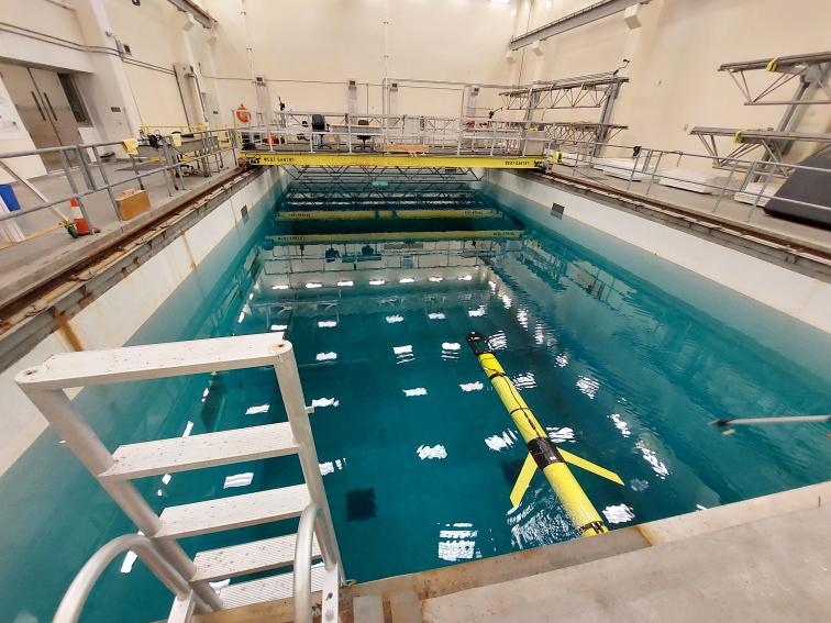 A yellow Slocum glider in an Olympic swimming pool-sized test tank.